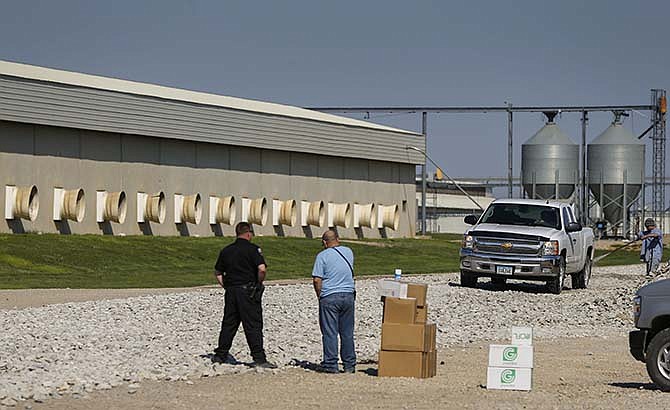 In this April 23, 2015 photo, trucks are sprayed with disinfectant before leaving Sunrise Farms in Harris, Iowa. The northwest Iowa farm has said it will kill its 3.8 million laying hens because of the bird flu virus. The Iowa infection is one of the largest to hit midwestern states where the virus has cost turkey and chicken producers millions of birds since early March. (Zach Boyden-Holmes/The Des Moines Register via AP)