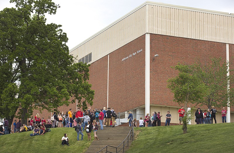 Students at Jefferson City High School stand outside after smoke was spotted in the Little Theater, leading to a full evacuation while firefighters investigated the smoke's origin.