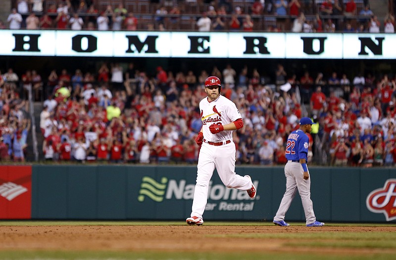 Mark Reynolds of the Cardinals rounds the bases after hitting a grand slam during the first inning of Monday night's game against the Cubs at Busch Stadium.