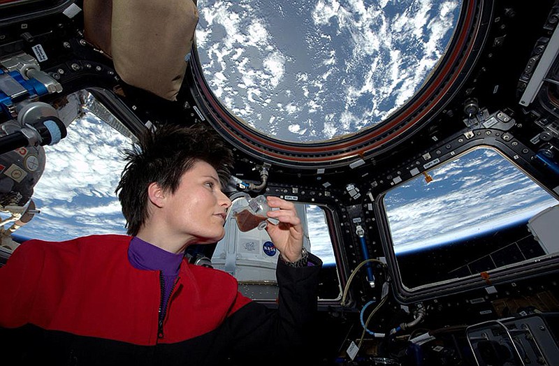 Italian astronaut Samantha Cristoforetti sips espresso from a cup designed for use in zero-gravity, on the International Space Station.