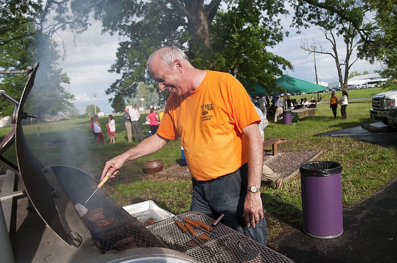 Callaway County Western District Commissioner Doc Kritzer grills hamburgers and hot dogs on Tuesday at SERVE, Inc., located at 4901 County Road 304, during the Chamber of Commerce Business After Hours. The commission and SERVE, a local non-profit organization serving low-income families, collaborated for the event, which also kicked off Fulton Street Fair button sales. Street Fair buttons cost $2 each and can be purchased at Bank Star One, C&R Supermarket, Fulton Area Chamber of Commerce and Visitor's Center, The Callaway Bank, Exchange Bank and Central Bank.