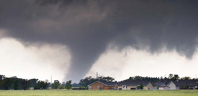 A tornado passes near Halstead, Kan., Wednesday, May 6, 2015. A swath of the Great Plains is under a tornado watch Wednesday, including parts of North Texas, Oklahoma, Kansas and Nebraska. 