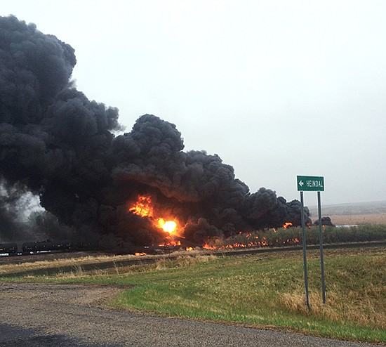 This photo shows smoke and fire coming from an oil train that derailed Wednesday in Heimdal, North Dakota. Officials say 10 tanker cars on the BNSF caught fire prompting the evacuation of Heimdal where about three dozen people live. No injuries were reported. 