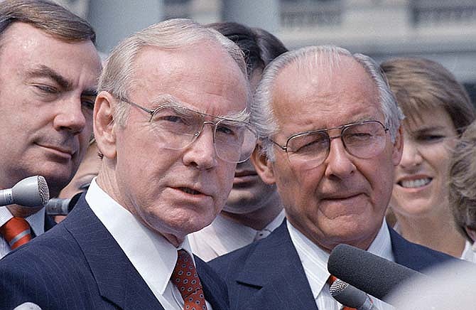 In this Aug. 5, 1987 file photo, then-House Speaker Jim Wright of Texas, left, and then-House Minority Leader Robert Michel of Ill. speak to reporters outside the White House in Washington. Wright, a veteran Texas congressman who was the first House speaker in history to driven out of office in midterm, has died. He was 92. 