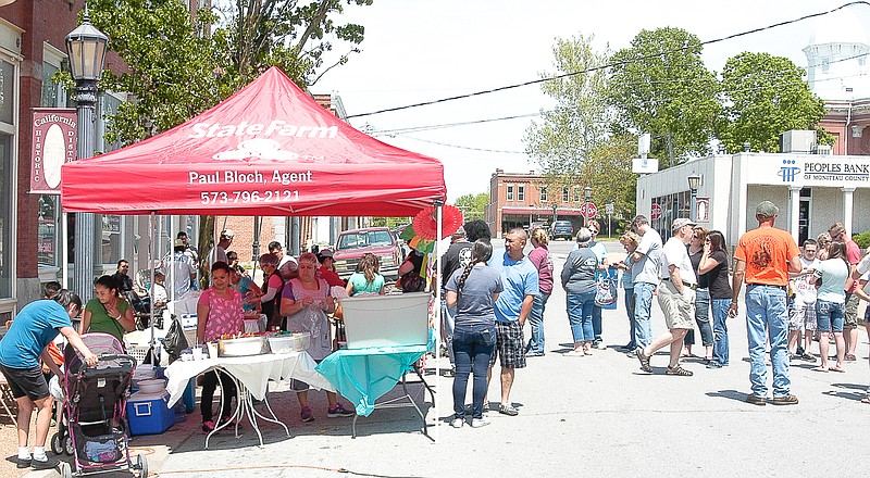 There is a line waiting for the food at this booth, as others visit in the street, at the second annual Cinco de Mayo festival held Saturday in California.