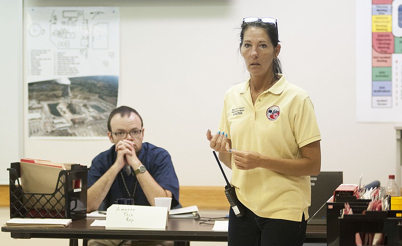 Callaway County Emergency Management Agency Director Michelle Kidwell briefs with officials Tuesday during a nuclear plant training exercise at the Callaway Emergency Operations Center.