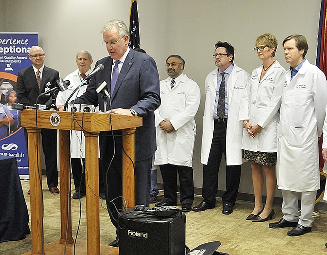 Flanked by doctors from St. Mary's Hospital, Gov. Jay Nixon signed new legislation Thursday regarding medical malpractice. The legislature renewed malpractice restrictions after the previous ones were overturned by the Missouri Supreme Court. 