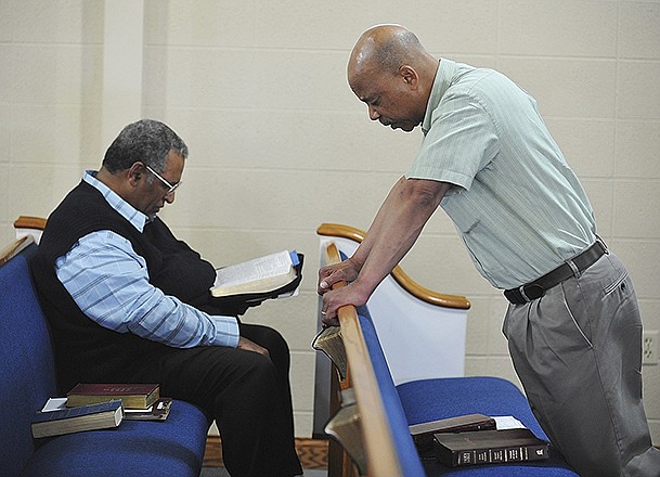 Pastor Cornell Sudduth, right, leads a prayer during Thursday's National Day of Prayer open house at Second Baptist Church. Rev. James Wheeler, left, swithched off with Sudduth for the first hour during which the two prayed for elected leaders and others in position of power to look to the Lord for guidance to make good and proper decisions. In addition to the prayers, they took turns leading hyms.