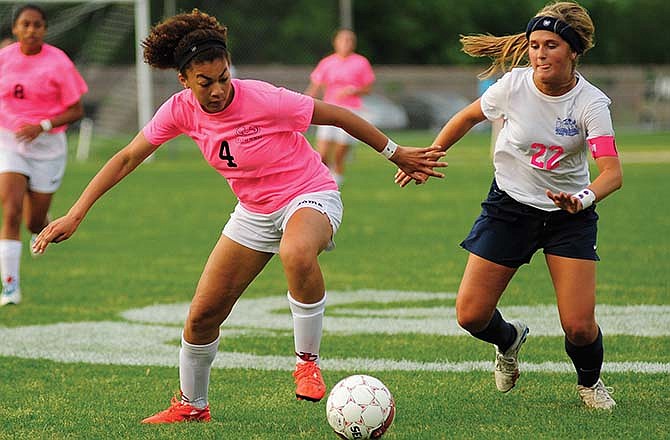 Jefferson City's Eden Hoogveld turns to make a run down the touch line after getting separation from Helias defender Maddie Lammers during the first half of Wednesday's "Pink Out" game at 179 Soccer Park.