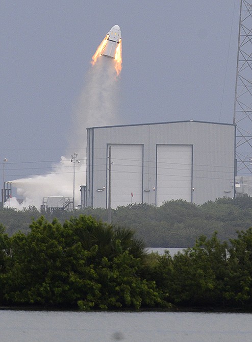 A SpaceX Dragon mock-up capsule blasts into the air on Wednesday during a test flight in Cape Canaveral, Florida. The unmanned flight was testing a new, super-streamlined launch escape system for astronauts. The California-based company led by billionaire Elon Musk aims to launch U.S. astronauts to the International Space Station as early as 2017. 