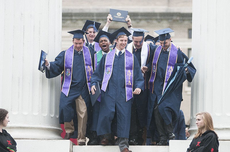 Westminster College graduates and members of Delta Tau Delta fraternity walk through the Columns on Saturday after receiving their diplomas. Per tradition, graduates walked through the Columns. Westminster had 195 graduates walk during its commencement ceremony and 204 students graduated from the college.
