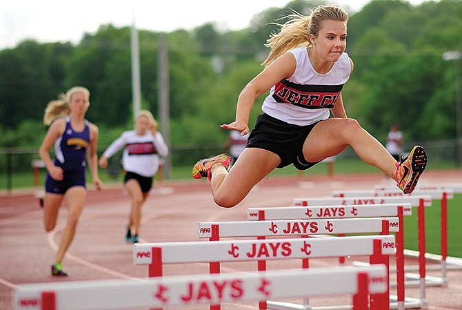 Jefferson City's Haley Watson sails over a hurdle while building a comfortable lead on the rest of the
field in the girls 300-meter hurdles during Friday afternoon's track meet at Adkins Stadium.