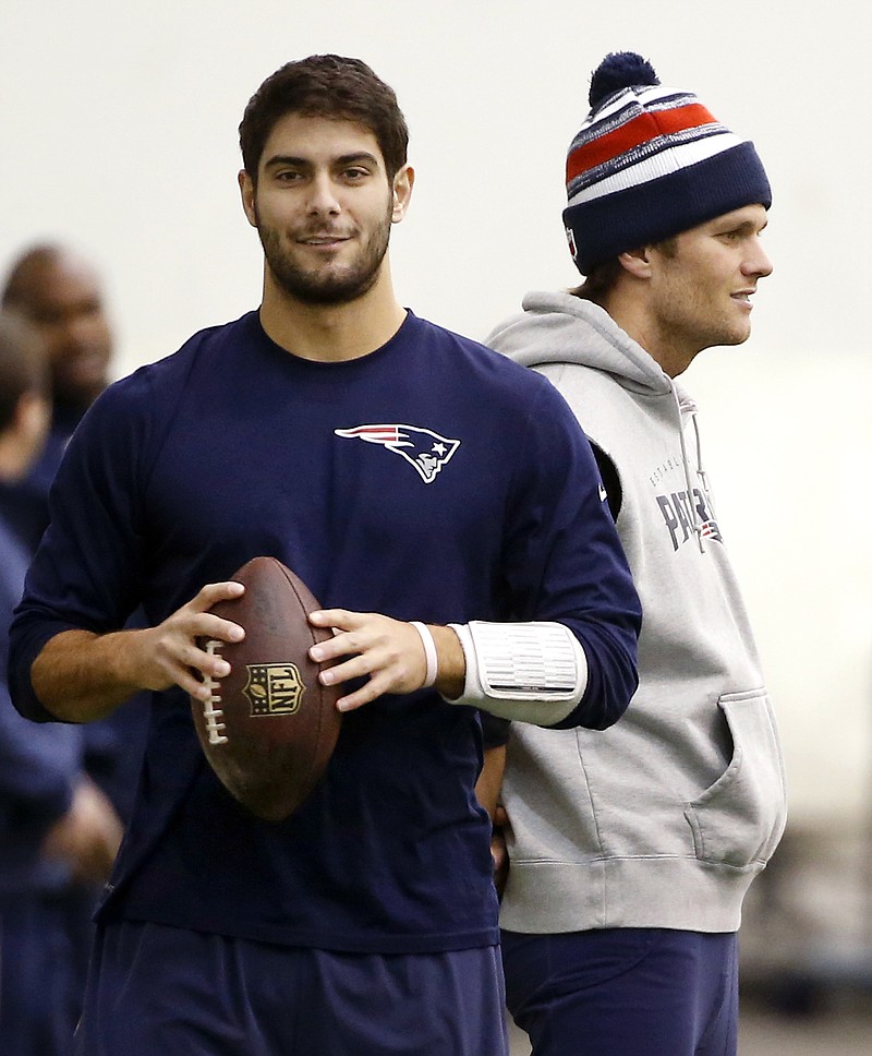 In this Jan. 23 file photo, Patriots backup quarterback Jimmy Garoppolo holds a football as starting quarterback Tom Brady stands by during a walkthrough at the team's facility in Foxborough, Mass.