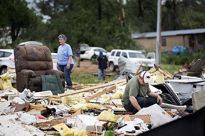 Ronnie Bevill sifts through the wreckage Monday looking for anything salvageable from his aunt's home. A section of the D&J Mobile Home Park in Nashville, Arkansas was destroyed after a EF2 tornado touched down late Sunday night.