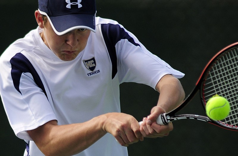 Helias' T.J. Hagenhoff keeps his eyes on the ball as he fires a backhand return during a doubles match Wednesday against School of the Osage at Washington Park. 