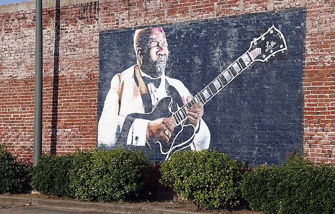 In this photo taken May 6, 2015, a wall mural of B.B. King overlooks a downtown parking area in Indianola, Miss. King claimed Indianola as his hometown after moving there as a teenager. The influence of the acclaimed "King of the Blues," is seen throughout the small Mississippi Delta town. King died Thursday night, May 14, 2015, at age 89 in Las Vegas, where he had been in hospice care.