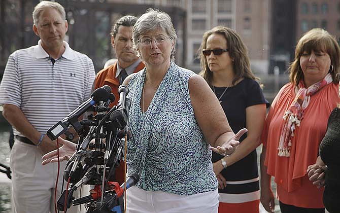 Boston Marathon bombing victim Karen Brassard, surrounded by fellow victims, speaks to members of the media after the death penalty verdict for Dzhokhar Tsarnaev outside the John Joseph Moakley United States Courthouse Friday May 15, 2015, in Boston. Tsarnaev was charged with conspiring with his brother to place two bombs near the Boston Marathon finish line that killed three and injured 260 spectators in April 2013. 
