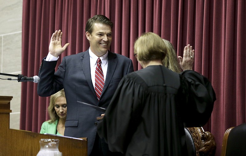 Todd Richardson, left, is sworn in as the new Missouri House Speaker by Missouri Supreme Court judge Patricia Breckenridge on Friday, May 15, 2015, in Jefferson City, Mo. Richardson was elected unanimously to replace John Diehl who resigned after acknowledging he exchanging sexually suggestive text messages with a college freshman serving as a Capitol intern.