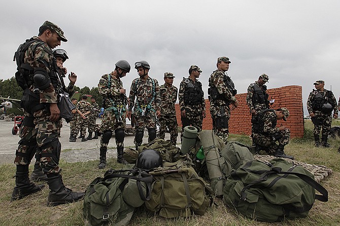 Nepalese army soldiers prepare to leave for a rescue mission to the site where the suspected wreckage of a U.S. Marine helicopter, that disappeared earlier this week while on a relief mission in the earthquake-hit Himalayan nation, was spotted, in Kathmandu, Nepal, on Friday.