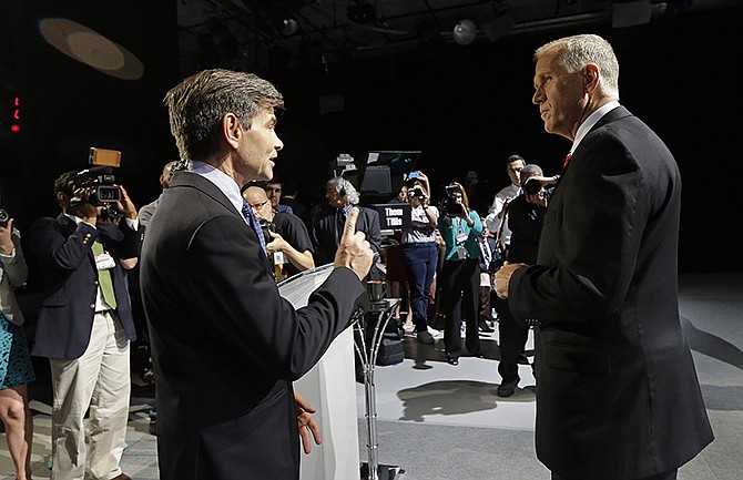 Moderator George Stephanopoulos, left, and North Carolina Republican Senate candidate Thom Tillis speak in 2014 prior to a live televised debate between Tillis and Sen. Kay Hagan, D-N.C., at UNC-TV studios in Research Triangle Park, North Carolina. 