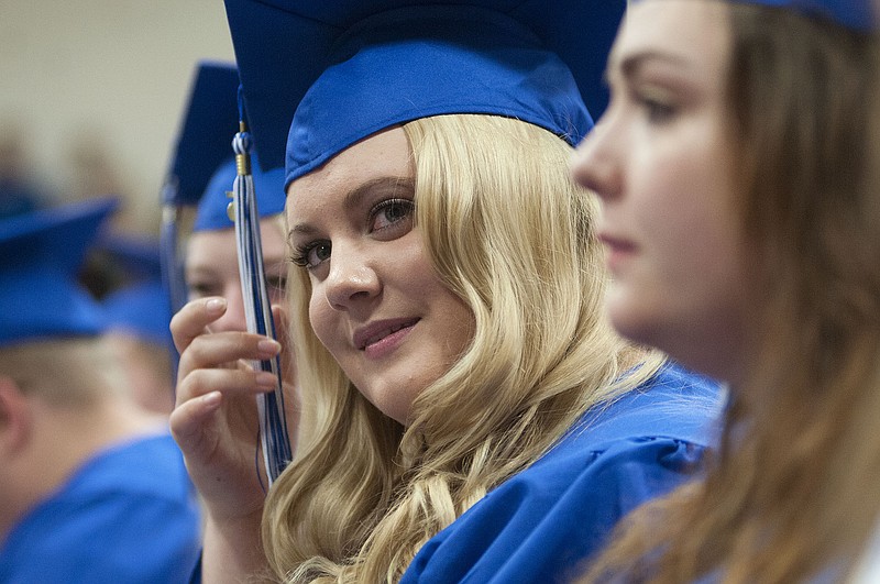South Callaway High School graduate Kacie Johnson plays with her tassle during the high school's graduation ceremony on Friday. There were 63 seniors who graduated, 33 of which earned scholarships for their higher education endeavors. Johnson is the recipient of a choir scholarship, academic scholarship and A+ scholarship to Columbia College. 