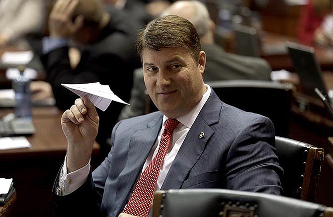 Rep. John Wiemann, R-St. Charles, prepares to throw a paper airplane on the House floor Friday near the end of the legislative session. 