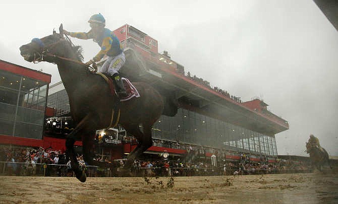 American Pharoah, ridden by Victor Espinoza wins the 140th Preakness Stakes horse race at Pimlico Race Course, Saturday, May 16, 2015, in Baltimore.