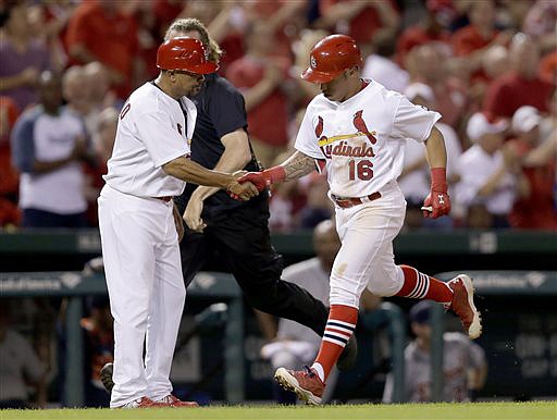 Kolten Wong is congratulated by Cardinals third base coach Jose Oquendo after hitting a solo home run Sunday night against the Tigers at Busch Stadium.