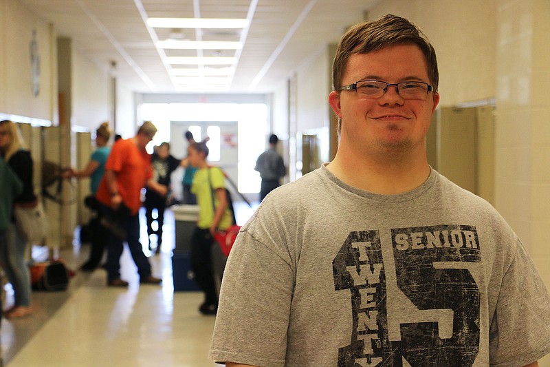 Chris Kampeter poses for a photo in the hallway at New Bloomfield High School on his last day Wednesday. Chris, a student with Down syndrome, graduated Friday. Chris bounced around from school to school for several years, his family attempting to find the right fit. New Bloomfield, his mother said, always made Chris feel included and happy. His parents agreed that they wish they would have enrolled Chris in New Bloomfield High School sooner so he could have spent longer than just a year there.