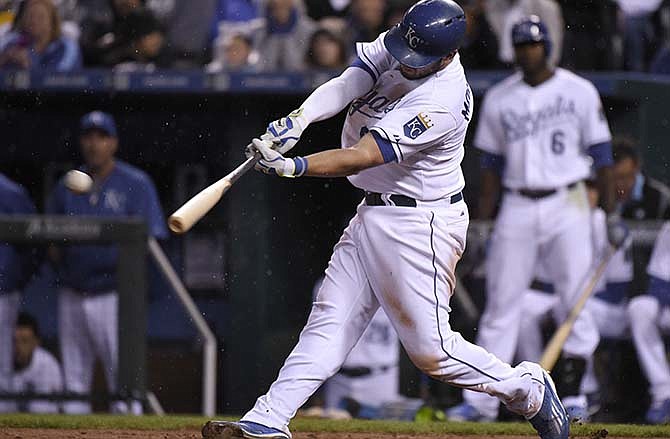 Kansas City Royals' Mike Moustakas hits an RBI double in the fifth inning during a baseball game against the Cincinnati Reds Tuesday, May 19, 2015, in Kansas City, Mo.