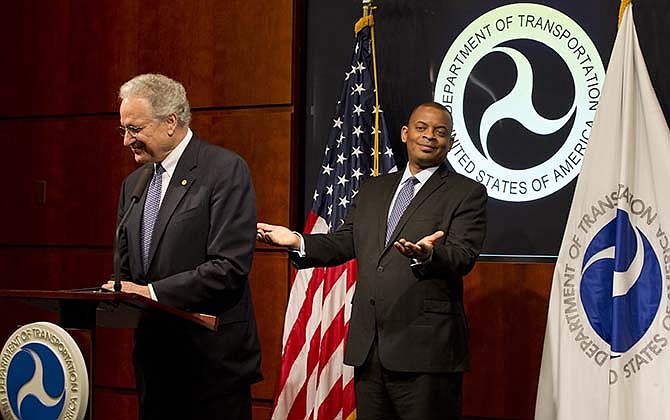 Transportation Secretary Anthony Foxx gestures behind NHTSA Administrator Mark Rosekind, during a news conference to talk about the Takata air bag inflator recall, Tuesday, May 19, 2015, at the Transportation Department in Washington. Air bag maker Takata Corp. has agreed to declare 33.8 million of its inflator mechanisms defective, effectively doubling the number of cars and trucks that have been recalled in the U.S. so far.