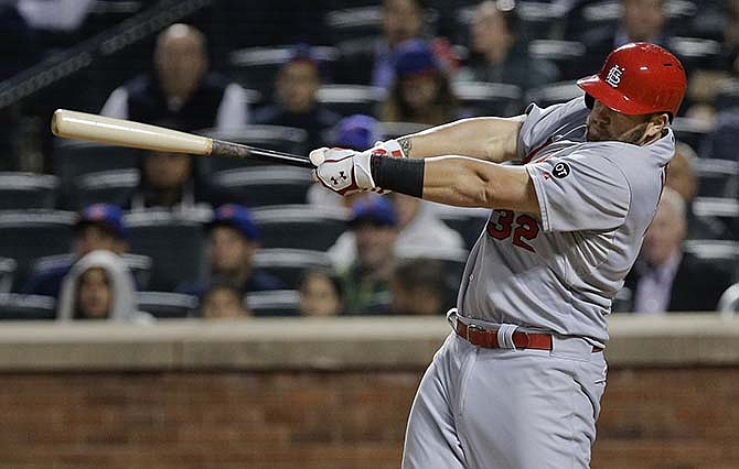 St. Louis Cardinals first baseman Matt Adams (32) follows through on a three run home run against the New York Mets during the fourth inning of a baseball game Wednesday, May 20, 2015, in New York. 