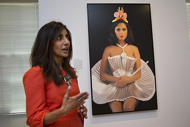 Asma Naeem, assistant curator of prints and drawings, speaks about a painting of singer Katy Perry, by artist Will Cotton, which is part of the gallery "Eye Pop: The Celebrity Gaze," at the National Portrait Gallery, Monday in Washington. 