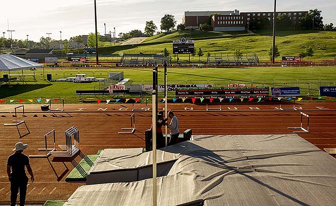 Workers install the pole vault pit in front of the stands Thursday at Dwight T. Reed Stadium on the
Lincoln University campus prior to the start of the MSHAA Class 1 and 2 state track meet this morning,
which runs through Saturday.