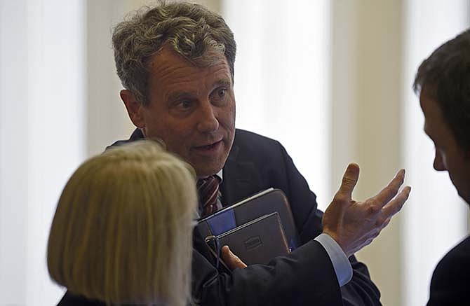 Sen. Sherrod Brown, D-Ohio, center, talks with Sen. Patty Murray, D-Wash., left, before the start of a meeting with Senate Democrats on Capitol Hill in Washington, Friday, May 22, 2015. Supporters of President Barack Obama's trade agenda sent a major trade bill to the House, where another fierce debate awaits. 