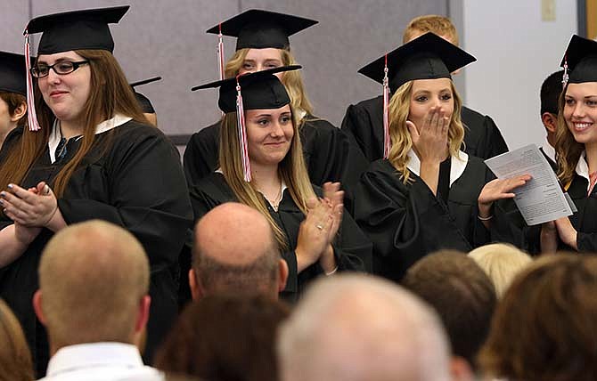 Senior Kathryn Stratman, third from left, makes eye contact with her parents and prepares to blow a kiss at them
following the commencement speech Saturday at Calvary Lutheran High School in Jefferson City. 