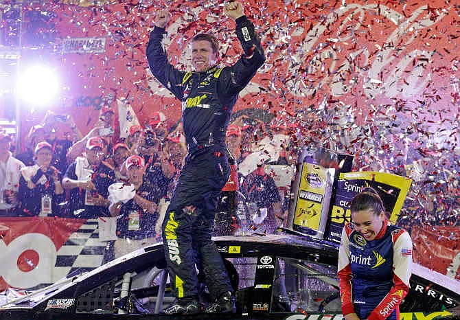 Carl Edwards celebrates in Victory Lane after winning the NASCAR Sprint Cup series auto race at Charlotte Motor Speedway in Concord, N.C., Sunday, May 24, 2015.