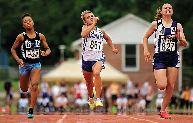 Jordan Barnhart of Russellville (center) tries to keep pace with North Platte's Regan Nash (right) as they surge ahead of University Academy's Jurnie Scott in the Class 2 girls 100-meter dash final Saturday at Dwight T. Reed Stadium in Jefferson City.