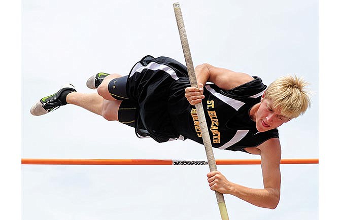 St. Elizabeth's Wyatt Stiles goes up and over the bar while competing in the Class 1 boys pole vault state championship on Saturday in Jefferson City.