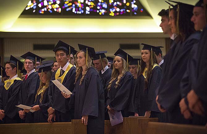 Graduating seniors sing along with their programs Sunday afternoon at St. Joseph Cathedral during the Helias Catholic High School Class of 2015 graduation ceremony. 