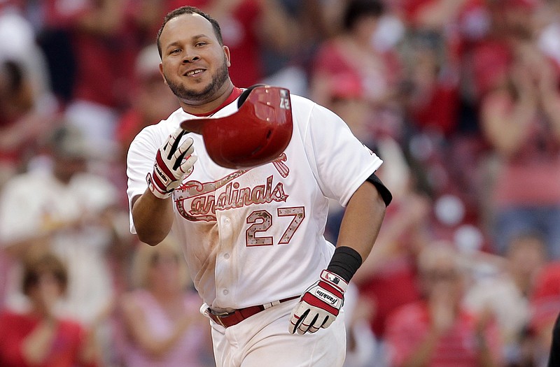 Jhonny Peralta of the Cardinals tosses his helmet as he heads for home after hitting a walk-off solo home run in the bottom of the 10th inning Monday against the Diamondbacks at Busch Stadium.