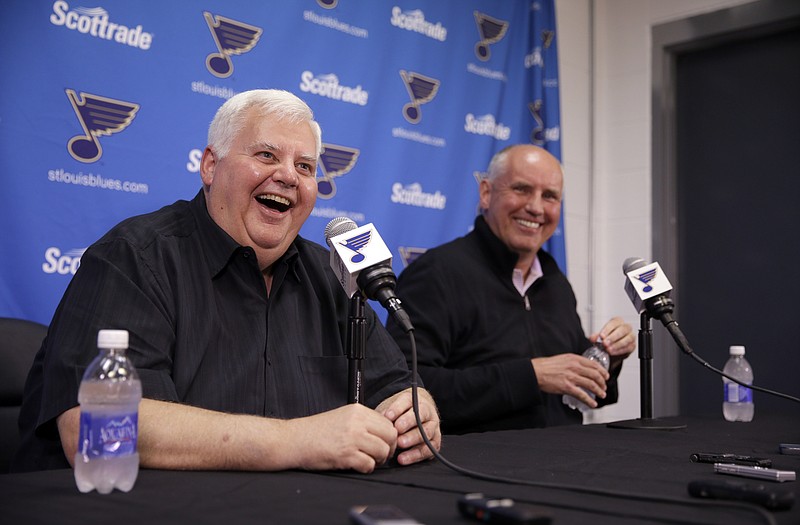 Blues head coach Ken Hitchcock smiles alongside general manager Doug Armstrong during a news conference Tuesday in St. Louis.