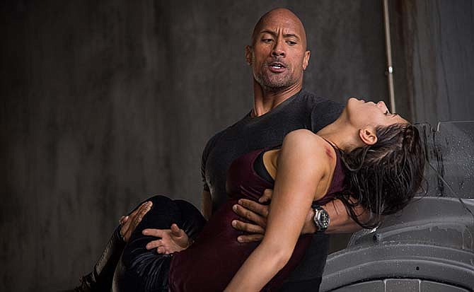 This photo provided by Warner Bros. Pictures shows Dwayne Johnson, left, as Ray, and Alexandra Daddario as Blake, in a scene from the action thriller, "San Andreas." 