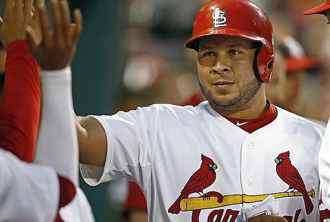 St. Louis Cardinals' Jhonny Peralta celebrates with teammates after scoring on a double by St. Louis Cardinals center fielder Randal Grichuk (not pictured) during the third inning of a baseball game against the Los Angeles Dodgers, Friday, May 29, 2015, in St. Louis.