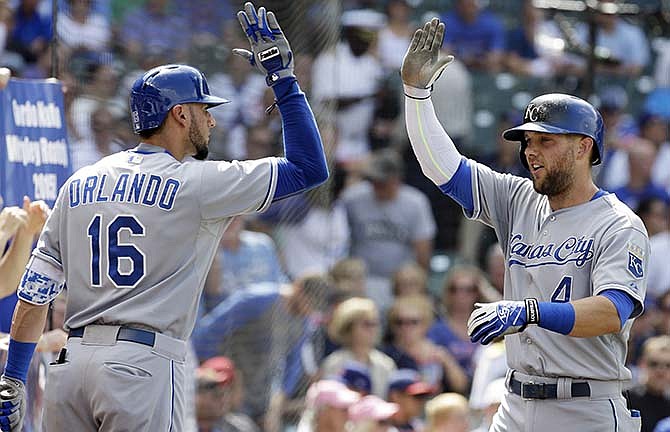 Kansas City Royals' Alex Gordon, right, celebrates with teammate Paulo Orlando after hitting a solo home run during the second inning of an interleague baseball game against the Chicago Cubs, Friday, May 29, 2015, in Chicago.