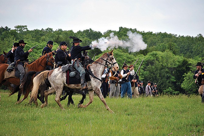 Union troops fire toward the enemy Saturday during the Battle of Monday's Hollow Re-enactment at Linn Creek, Mo.
