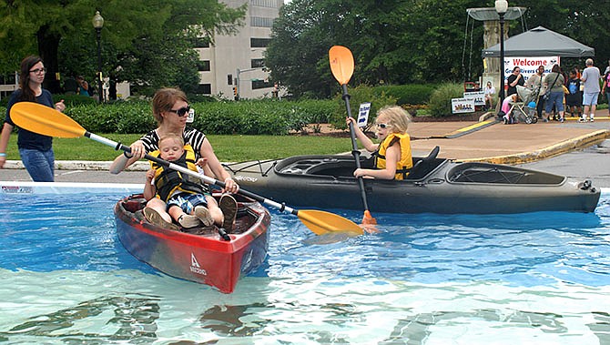 Jennifer Wood paddles with her son Kaleb in a two-person Kayak, while her
daughter Elaina learns to paddle on her own in the paddle pool at the Bass Pro
Outdoor Days at the Missouri Capitol Saturday afternoon. Bass Pro sponsored the outdoor
awareness event.