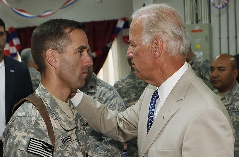 U.S. Vice President Joe Biden, right, talks with his son, U.S. Army Capt. Beau Biden, at Camp Victory on the outskirts of Baghdad, Iraq, in 2009.
