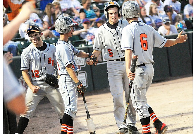 Junior catcher Derek Shikles (5) celebrates with teammates after scoring during New Bloomfield's five-run outburst in the fourth inning Wednesday night in the Class 2 semifinals against Norwood at T.R. Hughes Ballpark
in O'Fallon, Mo.