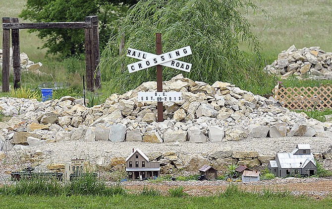 A work in progress, the O. C. Railroad Crossing is seen at Randy Hackman's residence on Elston Road. The outdoor garden railroad will feature a number of towns, mountains, bridges and tunnels.